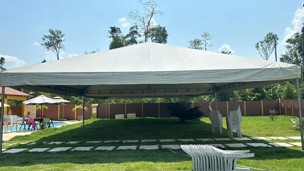 Tenda branca montada em gramado amplo